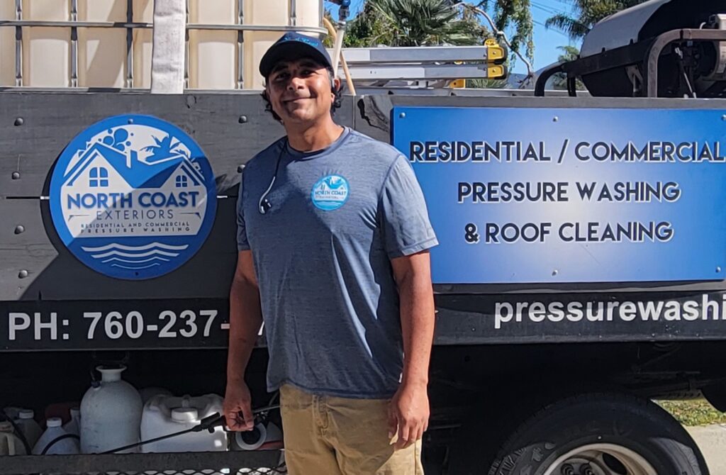 North Coast Exteriors owner beside the company truck and exterior-cleaning equipment