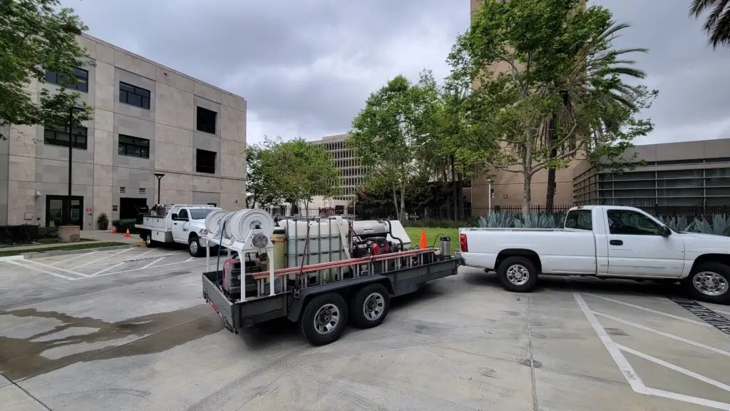 Commercial pressure-washing equipment staged at a large property