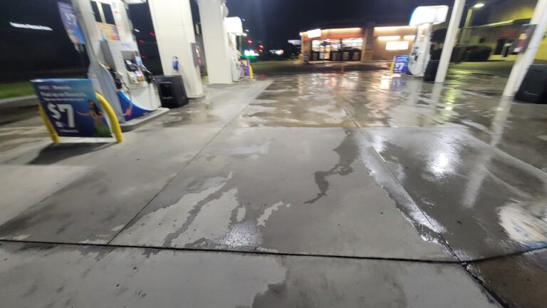 Gas station fuel pad pressure washing at night in North County San Diego